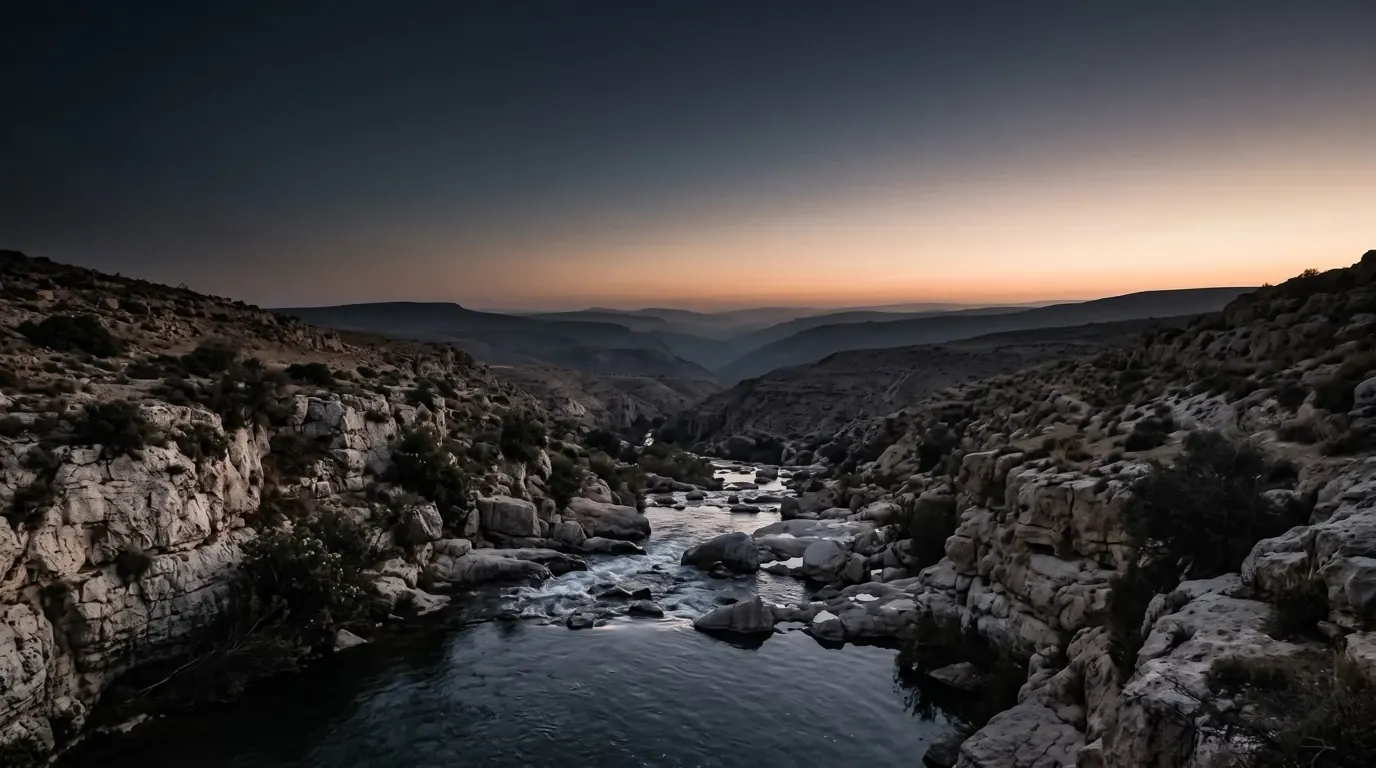 A mighty stream rolling fast over rocks through a gorge.