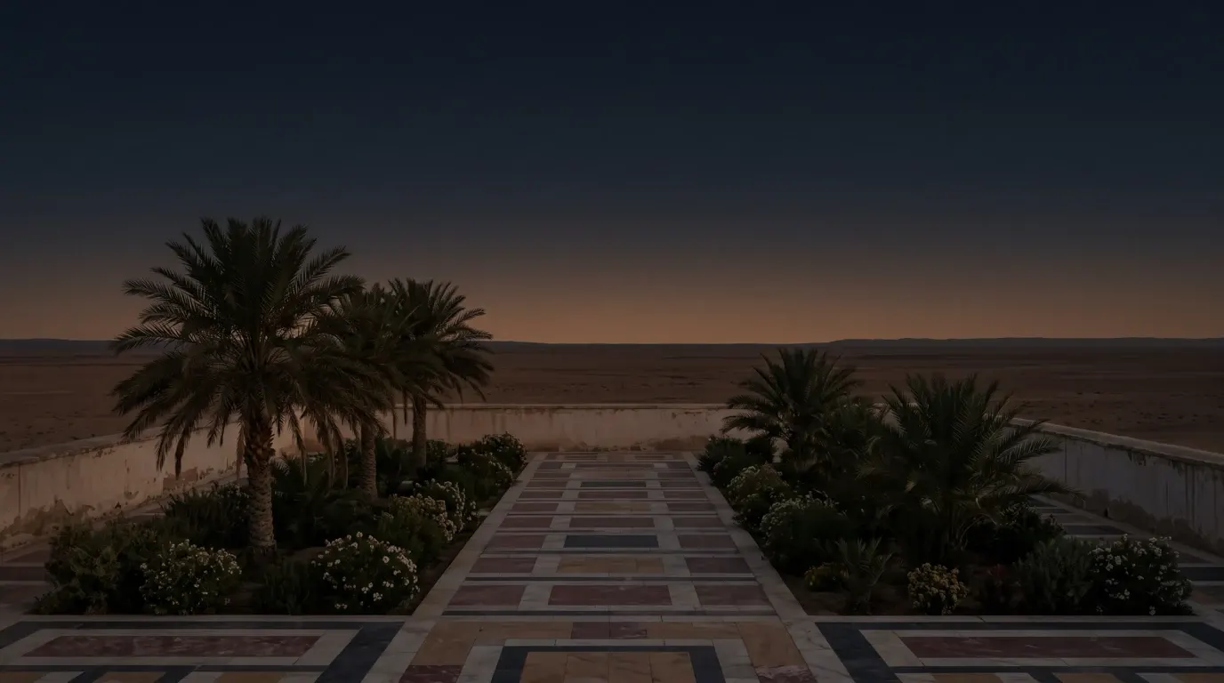 A palace garden court with a pavement of red, white, yellow and black marble between date palms and flowering shrubs, a flat plain beyond the wall.