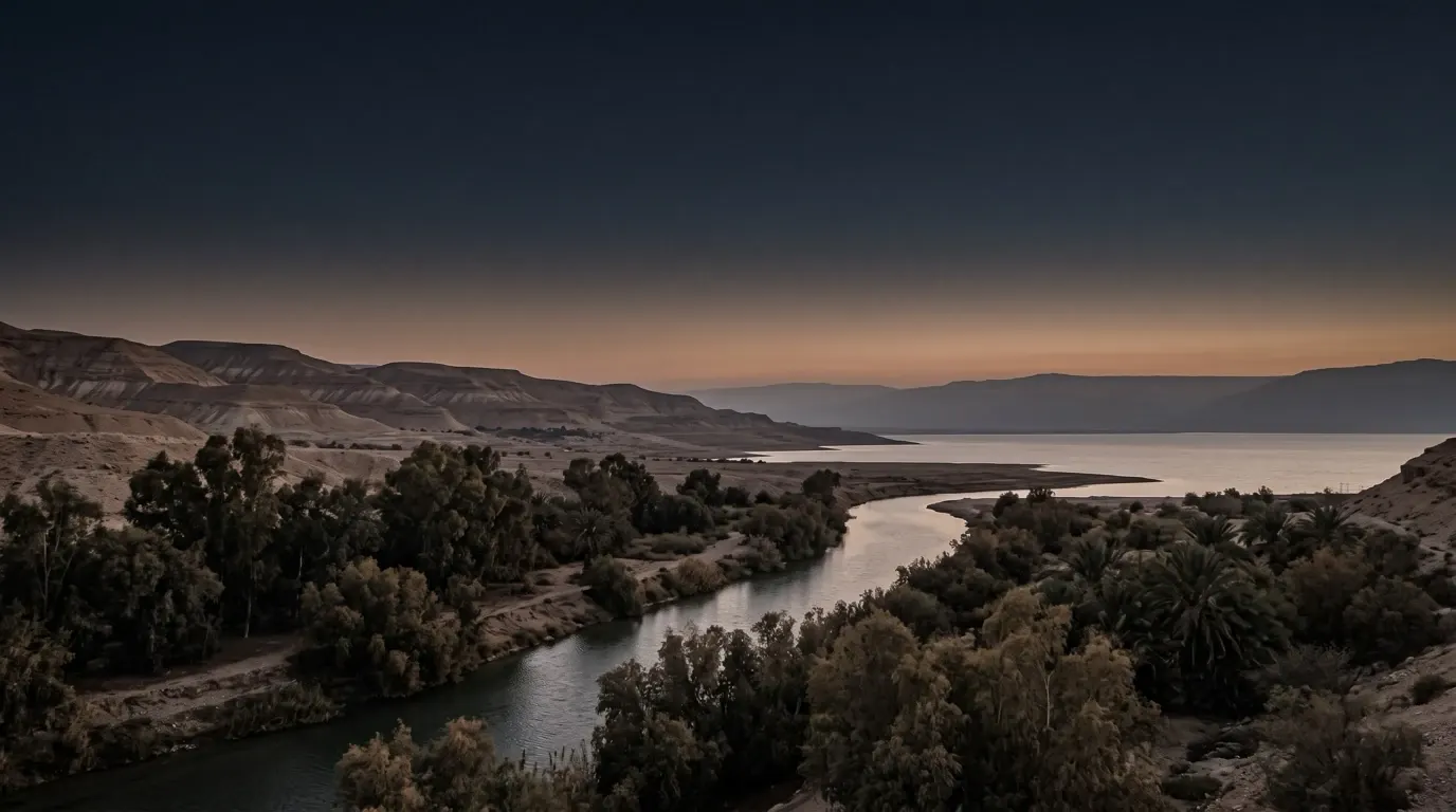 A river running down out of the hills into the salt sea, trees growing thick along its banks.