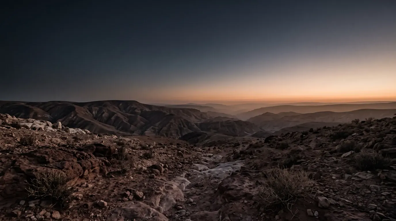 Red-brown mountains folding away to the horizon.