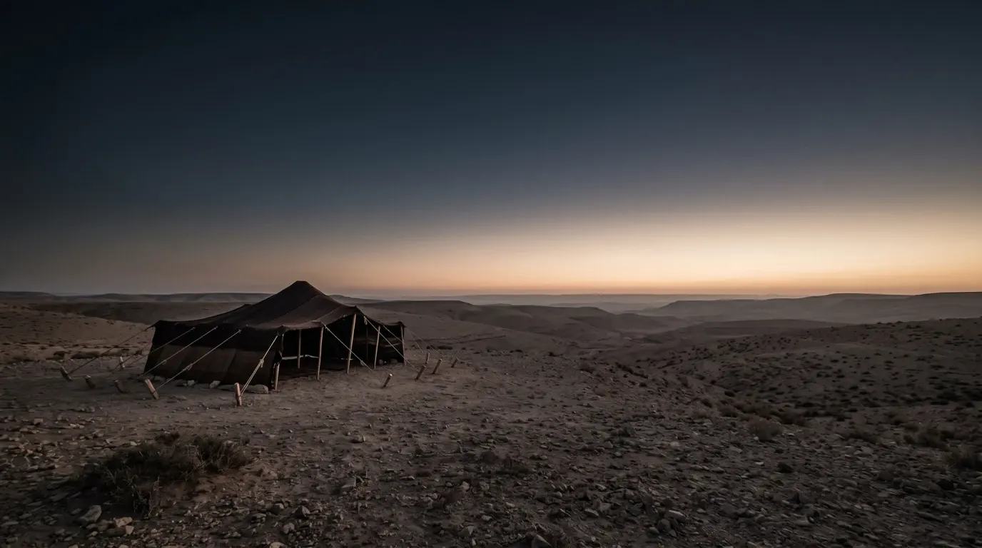 A wide dark tent of goat hair pitched in the desert, its cords stretched long to strong stakes.