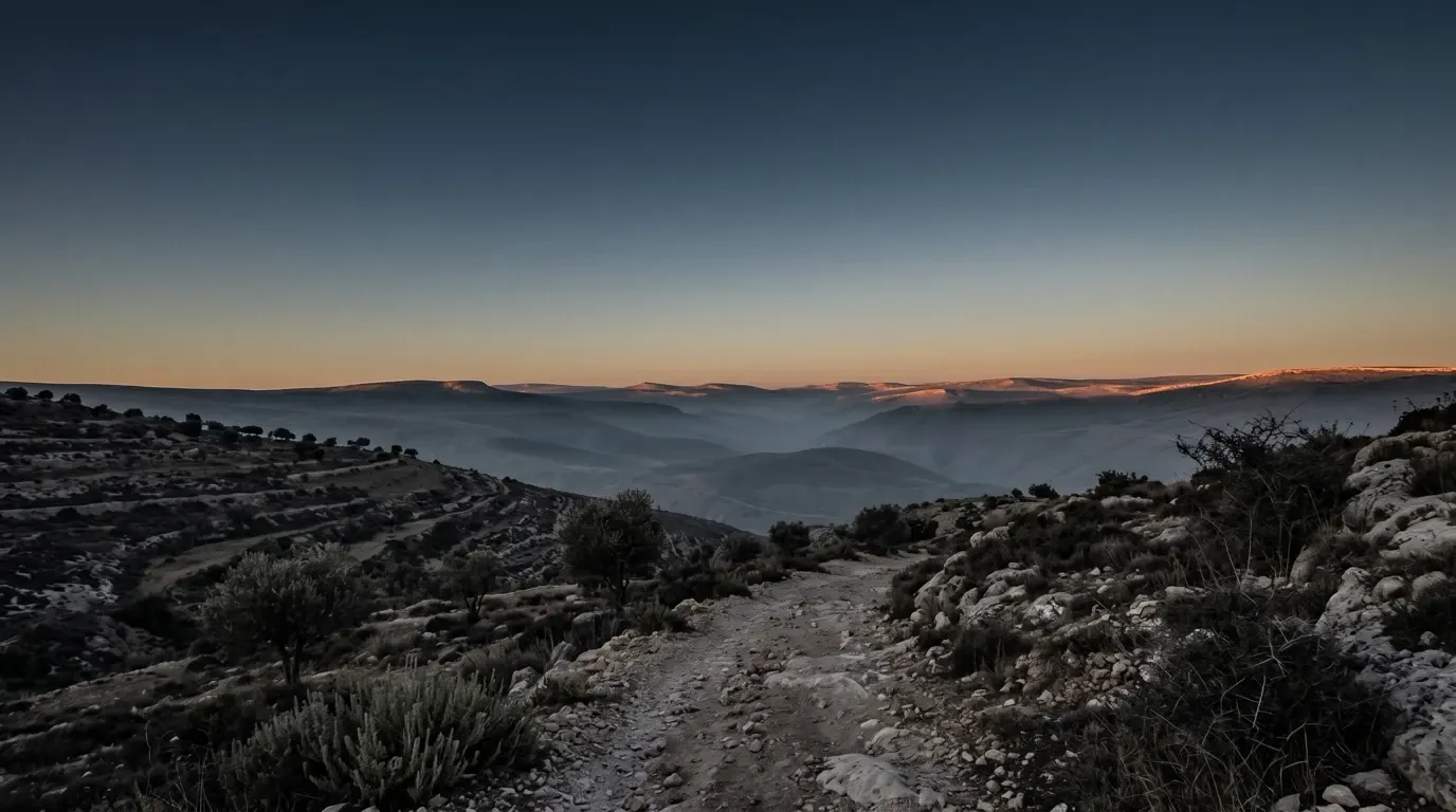The first light touching the high ridges while the valley below is still dark.