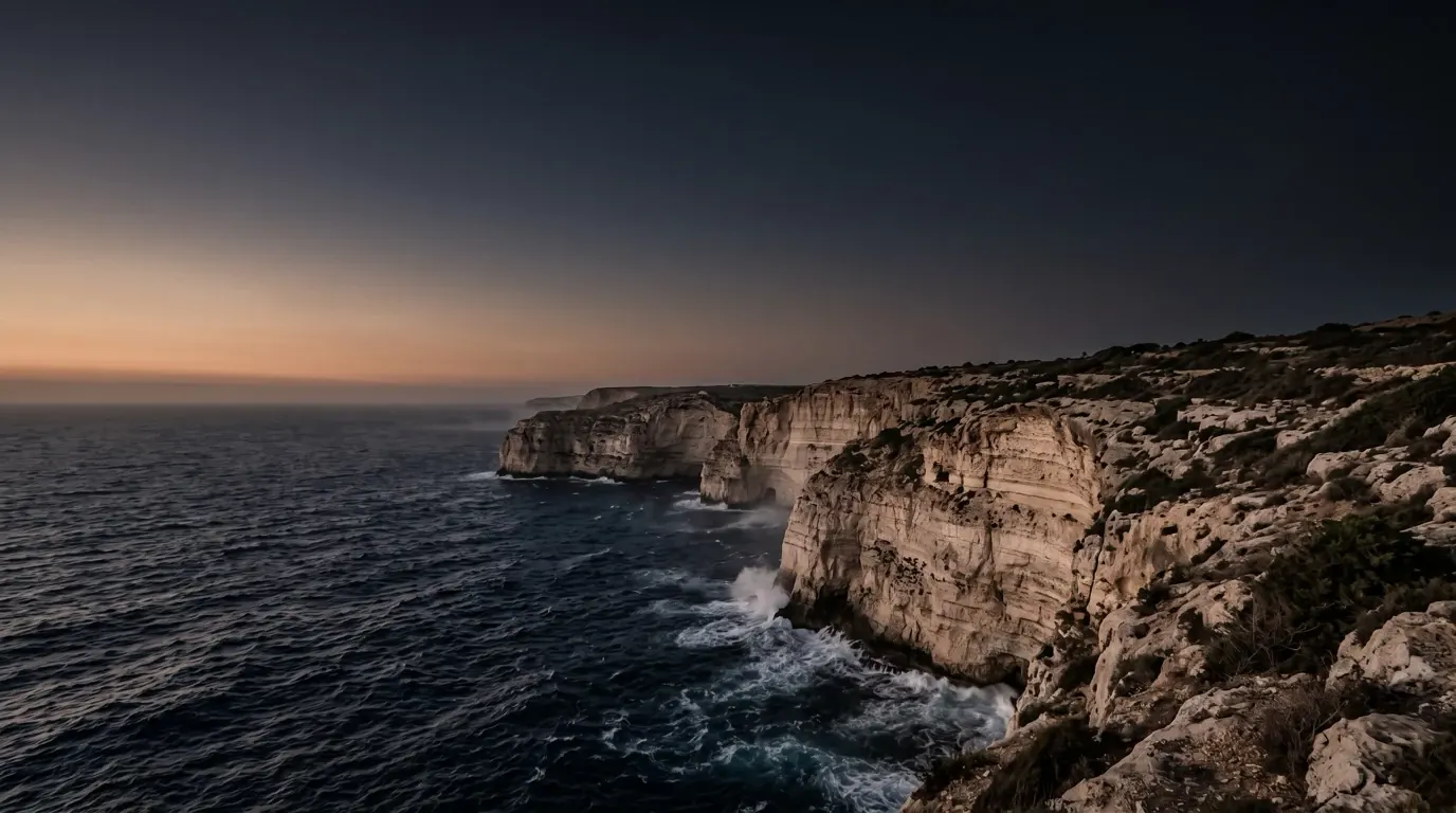 The sea breaking against high cliffs.