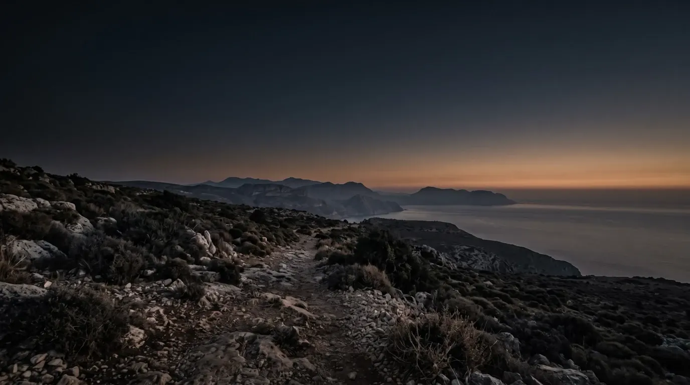 The far horizon over land and sea, seen from a coastal height.